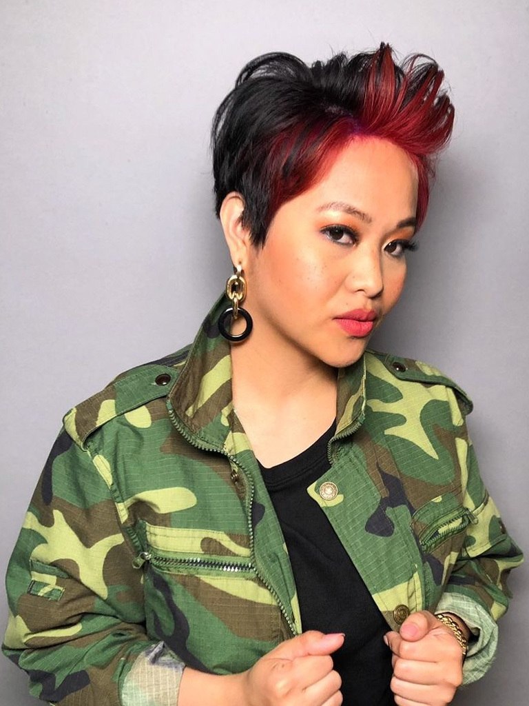Woman with short black and red pixie haircut