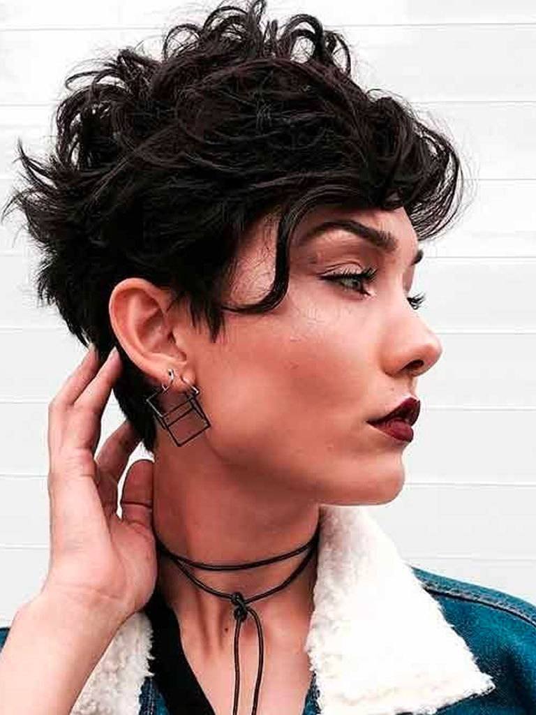 Woman with dark brown thick, messy bowl haircut