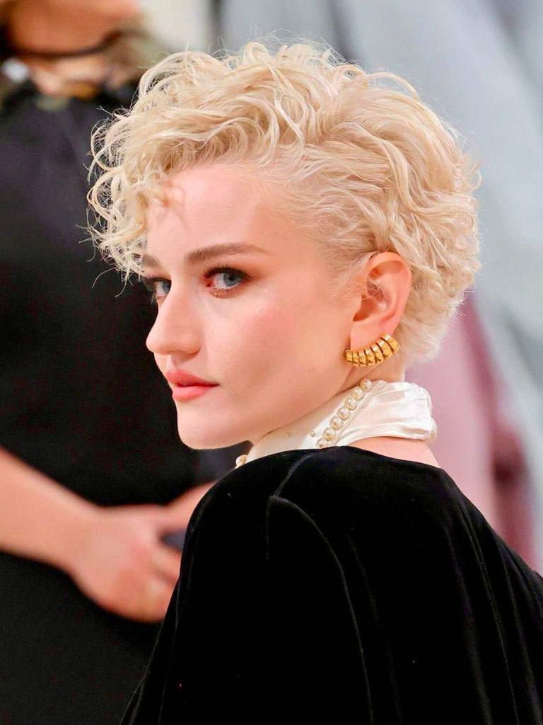 Julia Garner with soft curly mushroom cut with long fringe