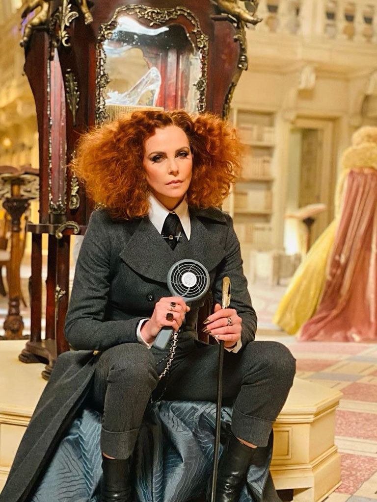 Charlize Theron with red hair in big waves and curls with long mushroom cut