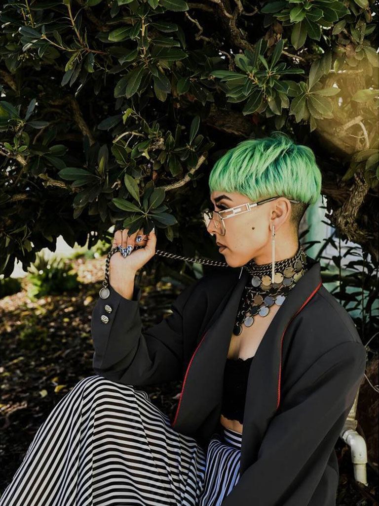 female model with mushroom cut, undercut and green hair