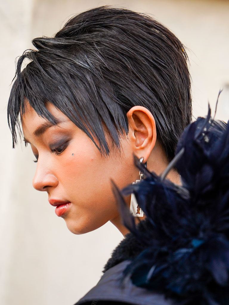 Woman with mushroom cut with wet look spiked hair