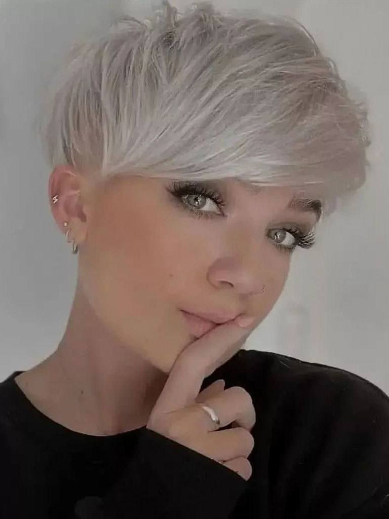 Woman with beautiful platinum toned pixie mushroom cut with undercut layer