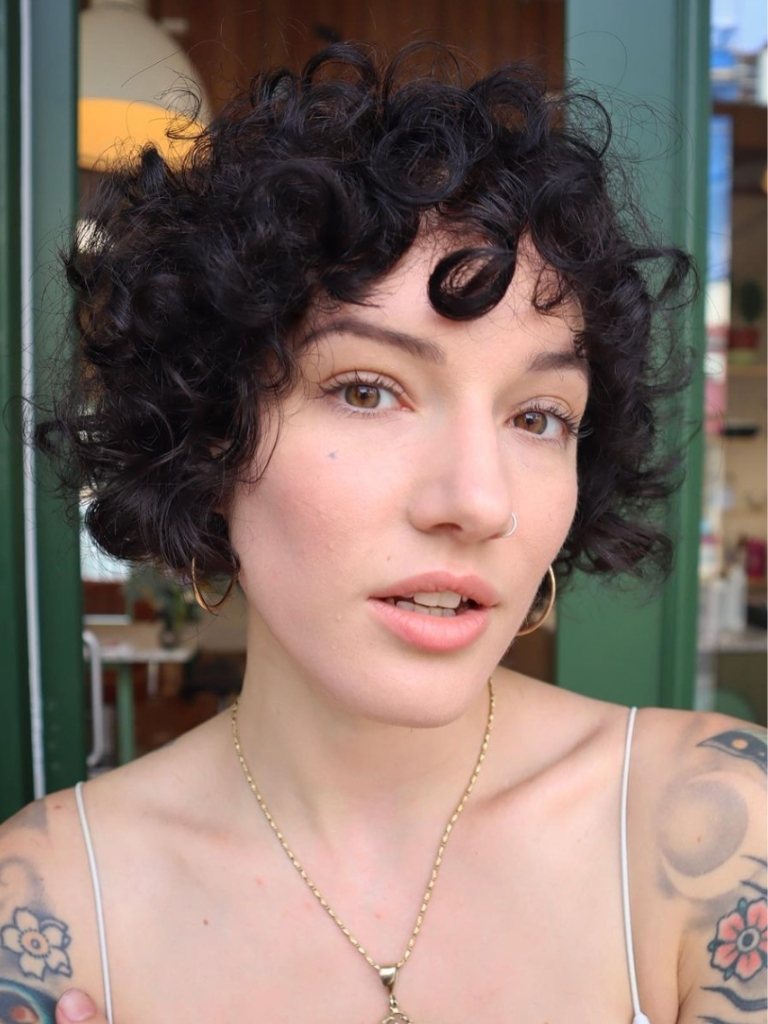 Woman with brown, short curly fringe hairstyle