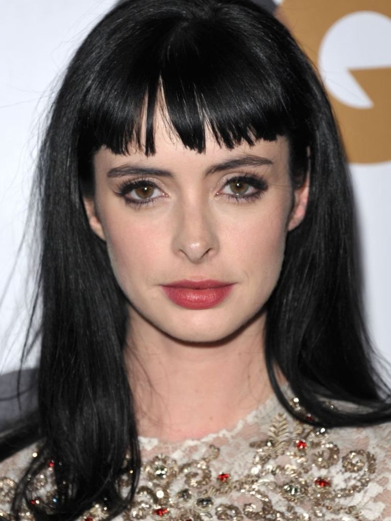 Krysten Ritter with short dark brown bangs and straight hair