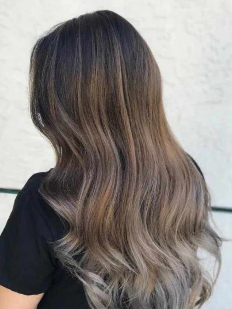 Woman with ash brown hair and balayage