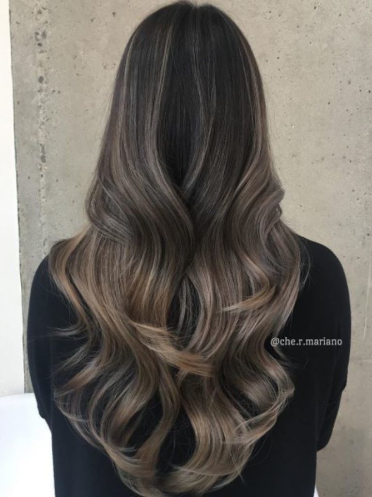 Woman with ash brown blend hair and waves