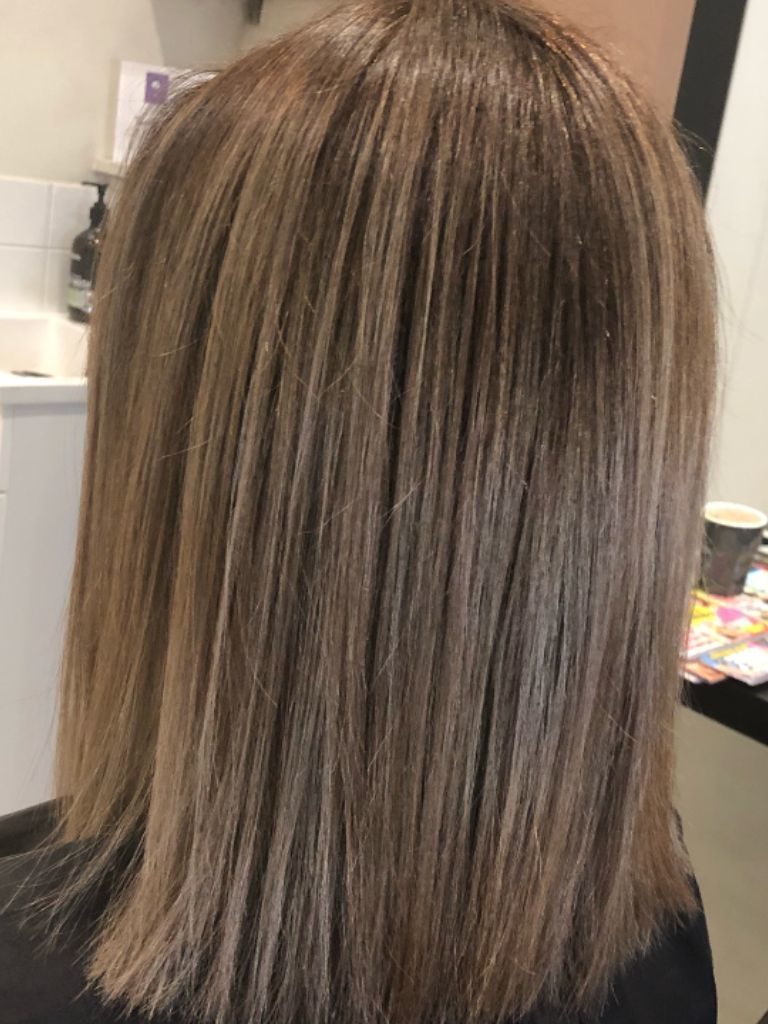 Woman with ash brown hair and highlights
