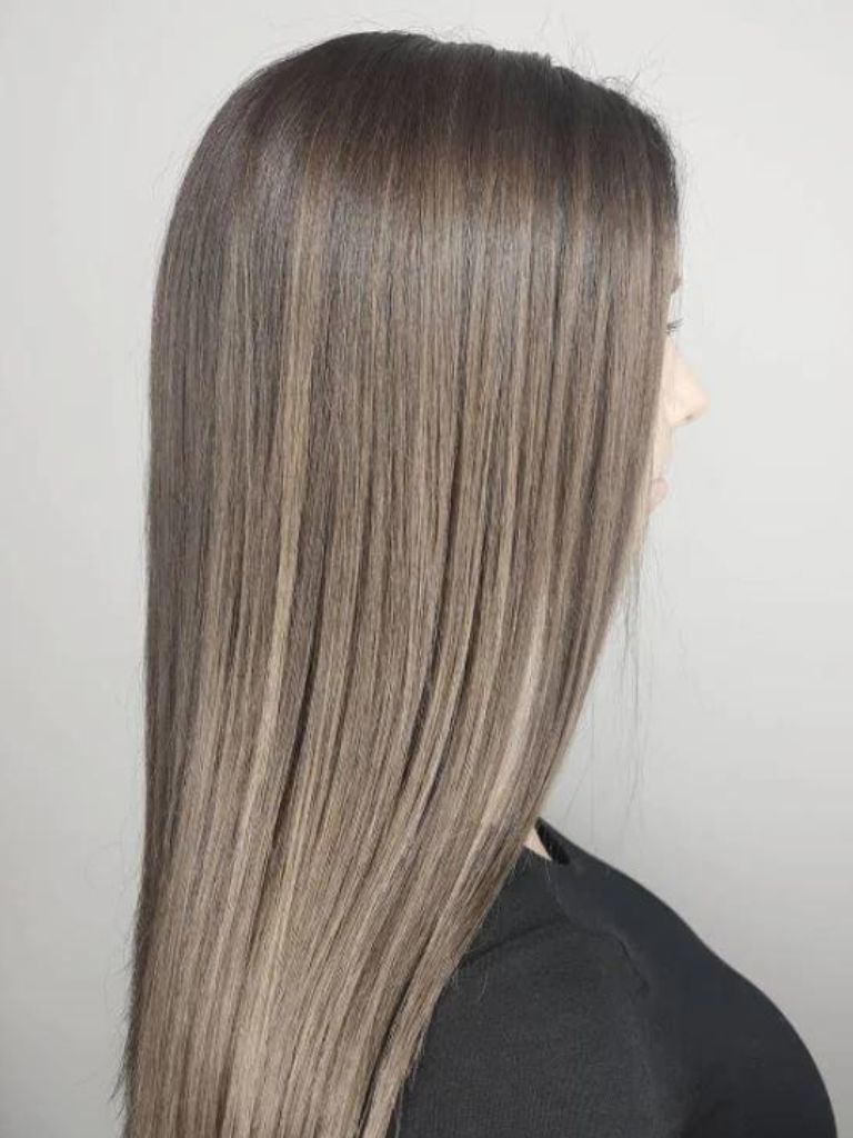 Woman with smokey balayage and ash brown hair