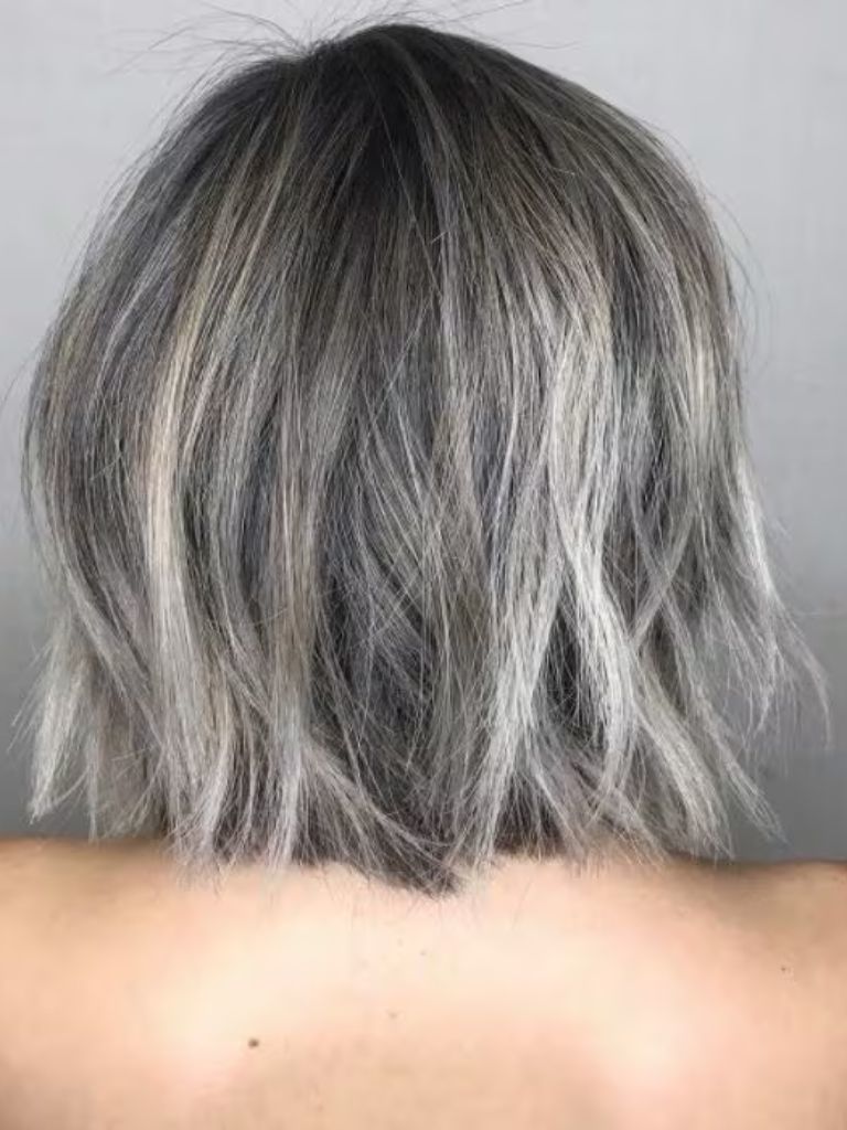 Woman with ash brown hair and icy platinum blonde tips
