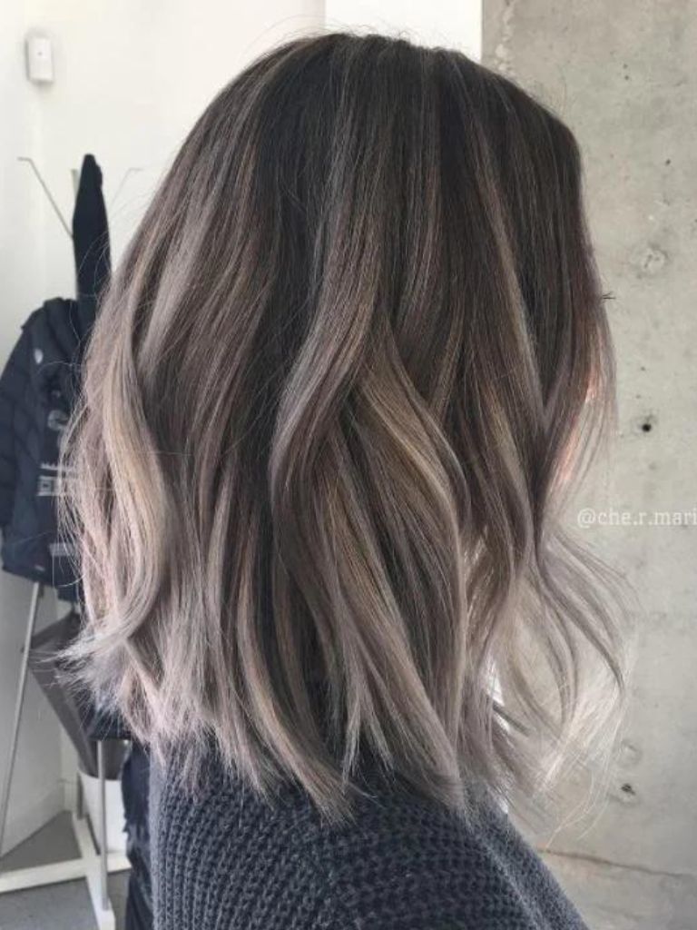 Woman with stark contrast ash brown hair