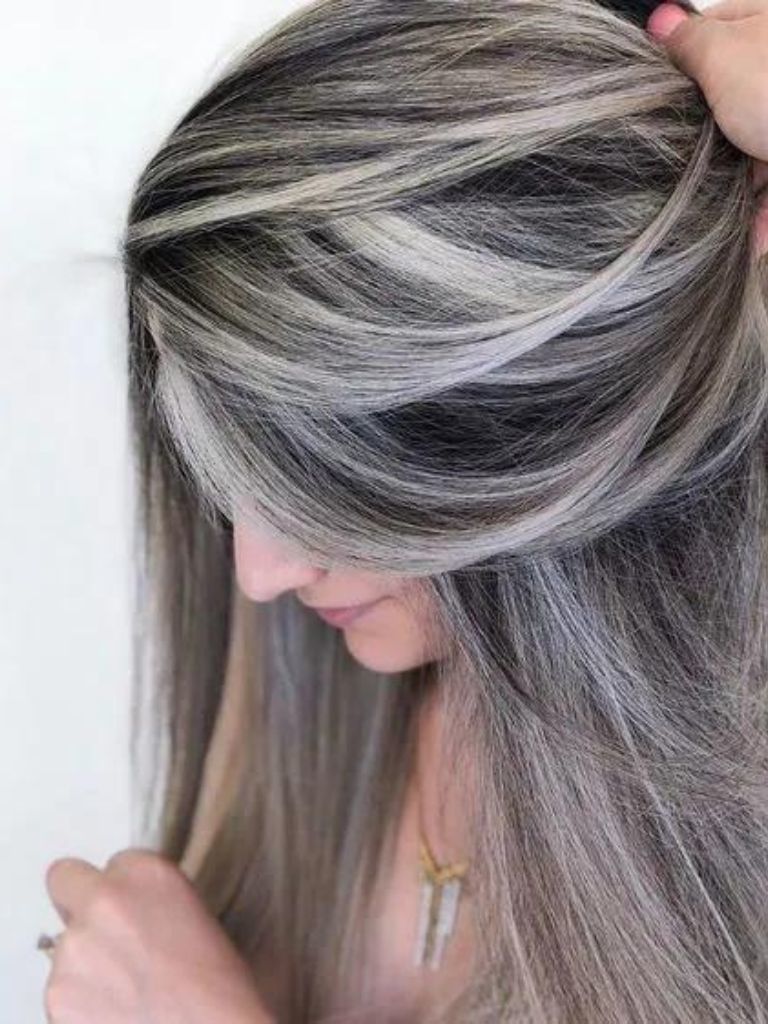 Woman with ash brown hair and platinum highlights