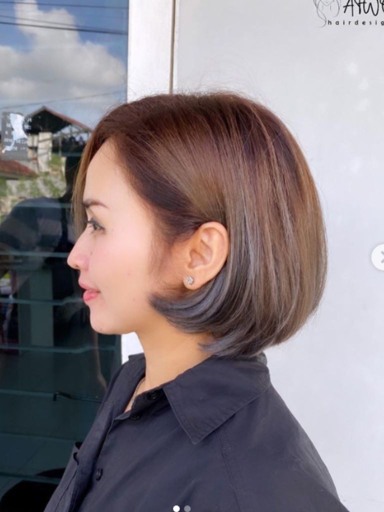 Woman with ash brown hair and bob