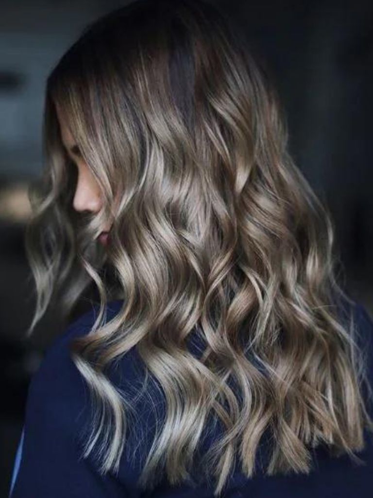 Woman with ash brown curly hair