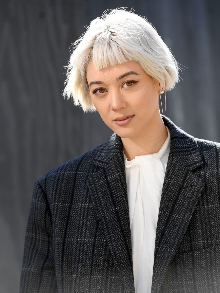 Woman with short ash white bob and fringe