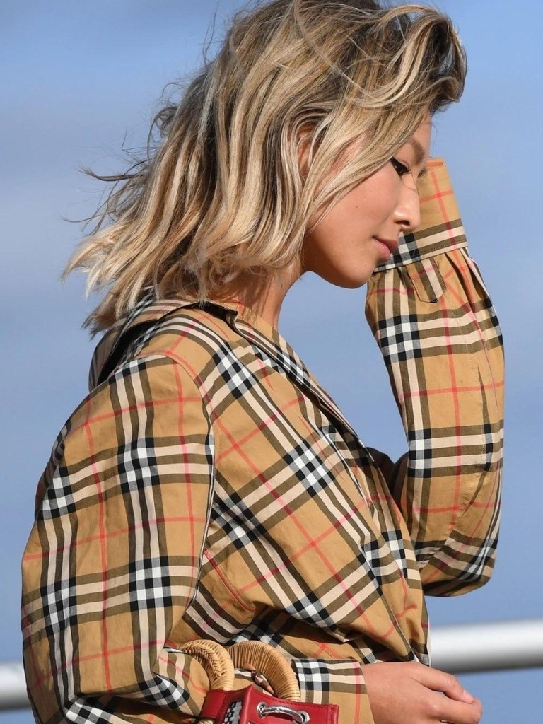 Woman with sandy blonde hair outdoors