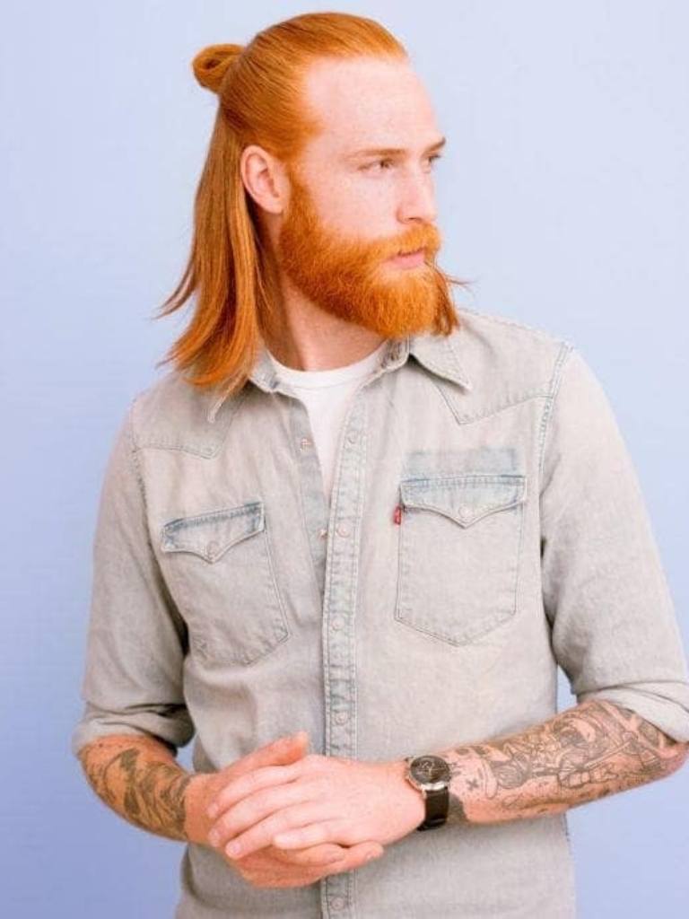 Viking Hairstyles: Shot of man with shoulder length ginger hair styled into a half-up, half-down bun