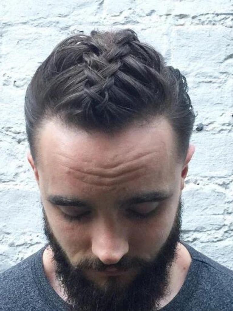 front view of a man with dark man braids and bun