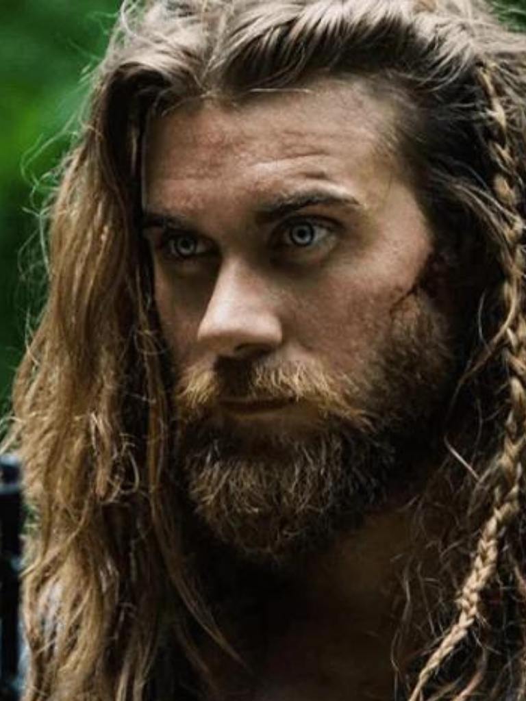 Brock O'Hurn with long hair and braids