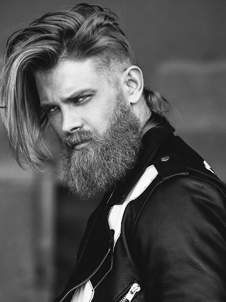 Viking hairstyles: Shot of man with full beard with long top hairstyle with low fade