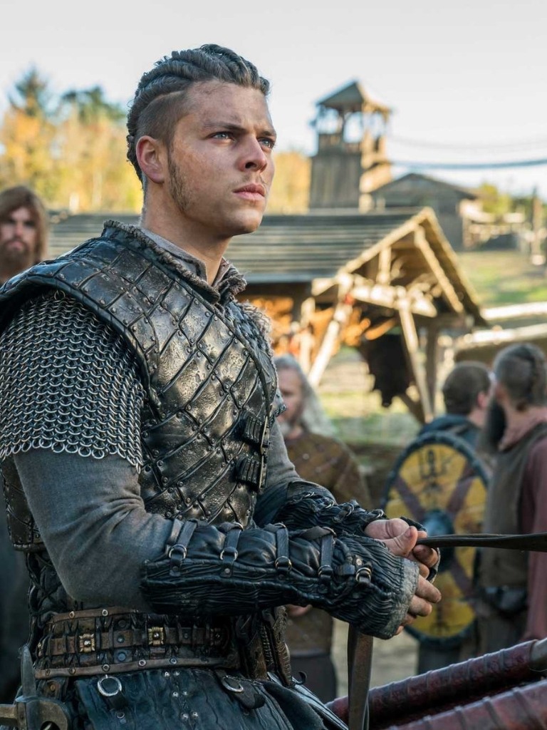 Viking Hairstyles: Vikings character with twisted back cornrows with undercut, wearing costume on set of Vikings