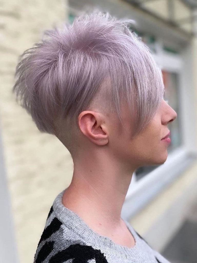 side view of a woman with her hair in a graduated mushroom haircut with undercut, dyed mauve
