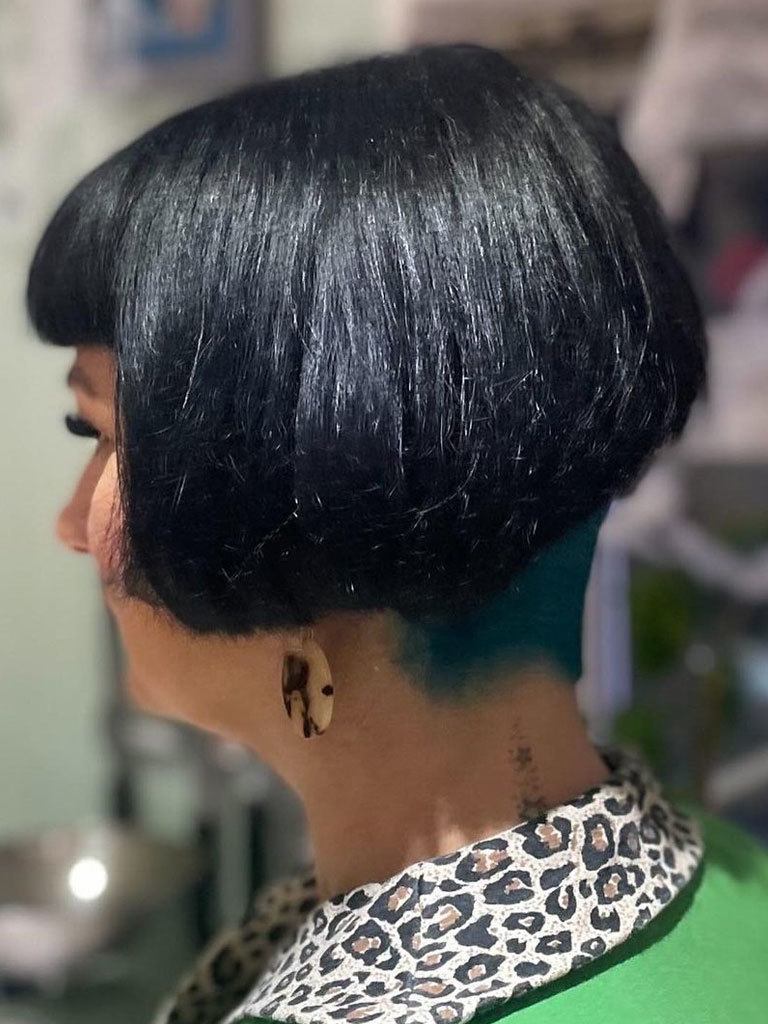 Woman with blunt mushroom cut with sharp graduated undercut at nape