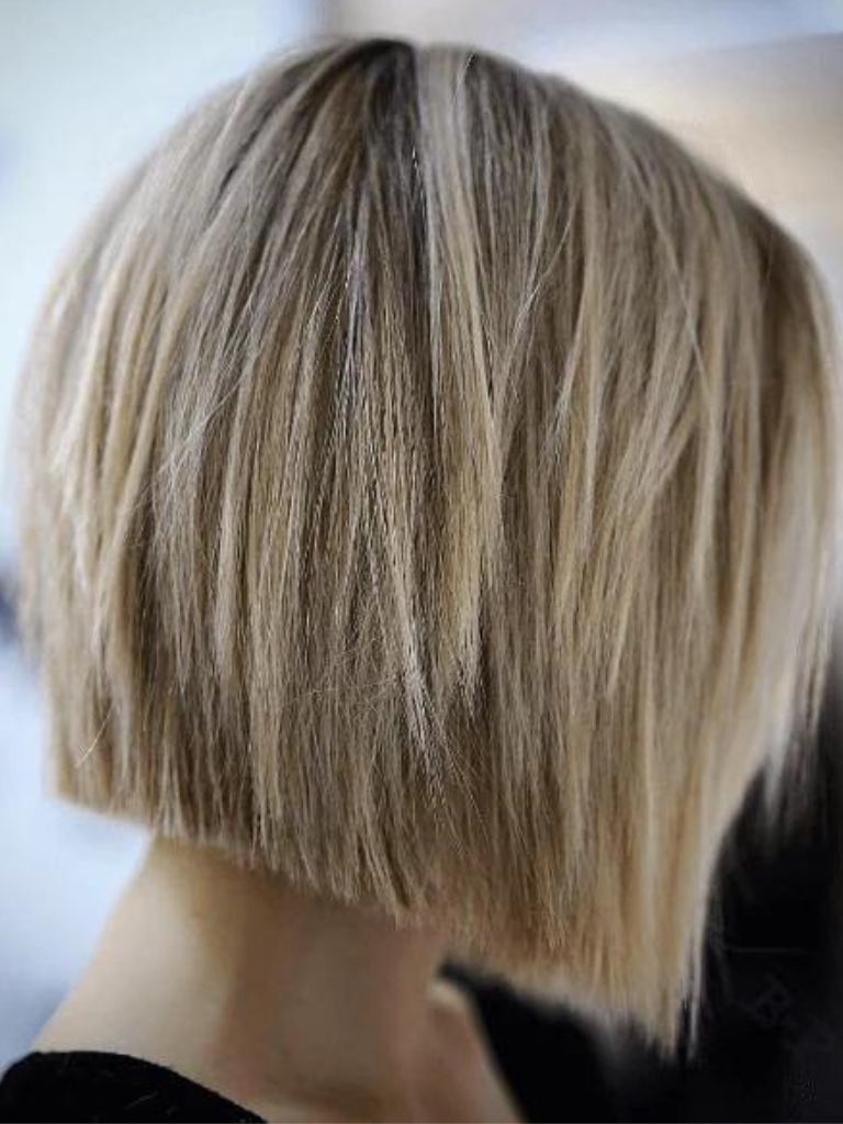 side view of a woman's hair with choppy blonde bob