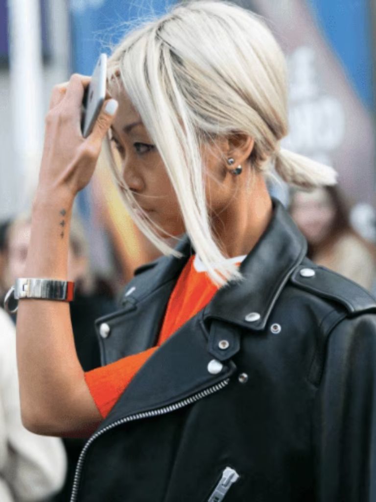side view of a woman with a platinum ponytail