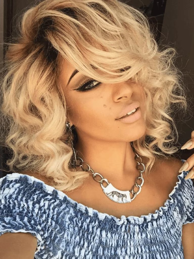 front facing image of a woman with a warm blonde bob - wavy hair