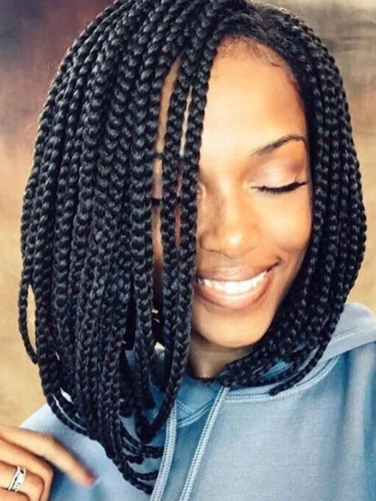 Box braids bob: Woman with dark brown short bob box braids smiling