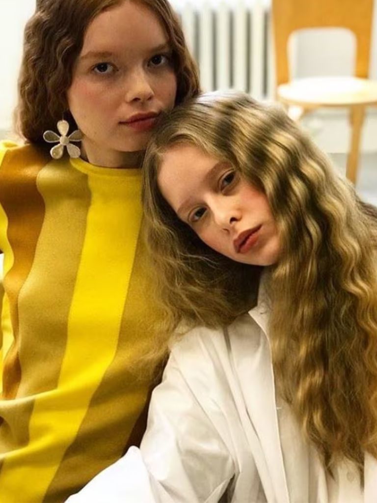 two woman with wavy crimped long hair