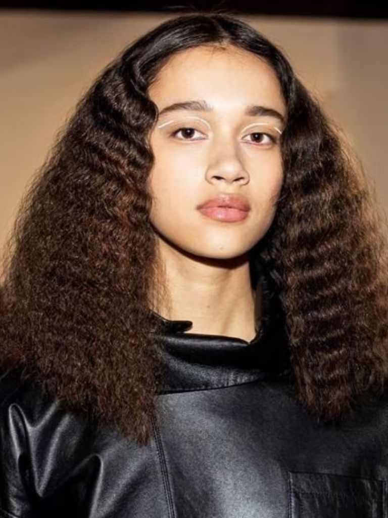 Woman with dark brown crimped wavy hair