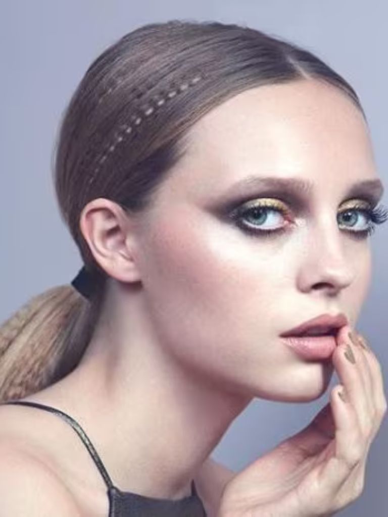 Crimped hair: Model with dark blonde straight hair in a low ponytail with accent crimped sections.