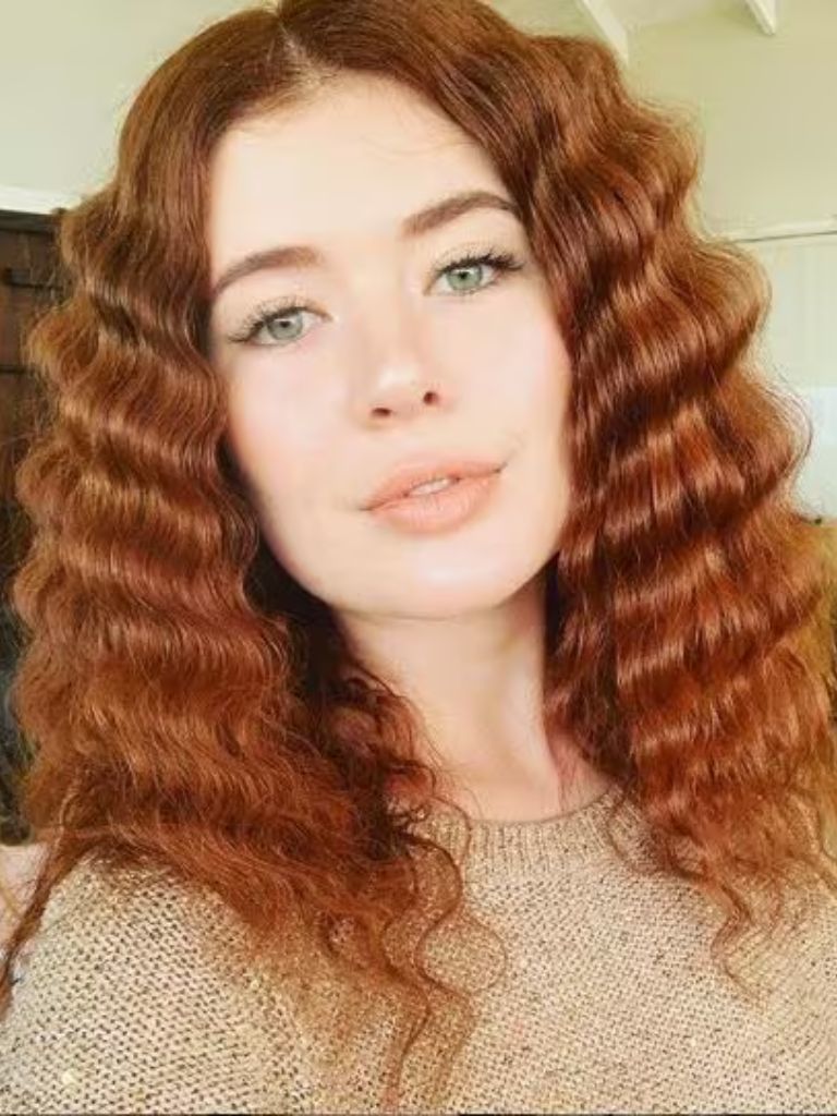 Woman with ginger crimped wavy hair