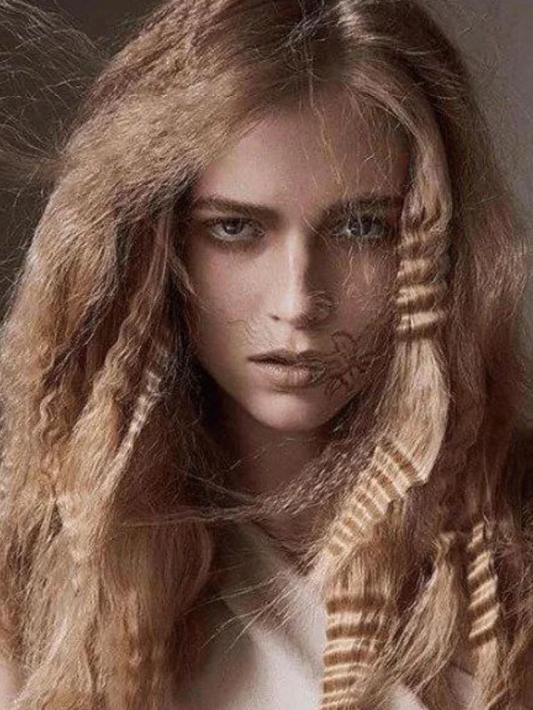 Crimped hair: Model with tousled crimped waves on long blonde hair.