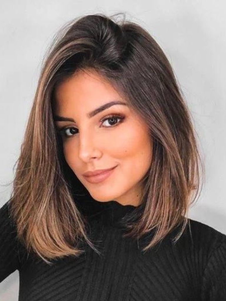 Woman with a long bob haircut with chocolate brown and caramel highlights