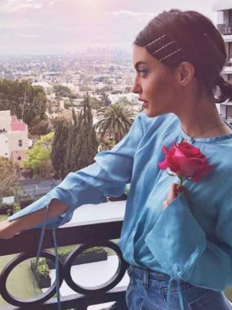 Woman with short brown hairstyle in low ponytail with hair slides