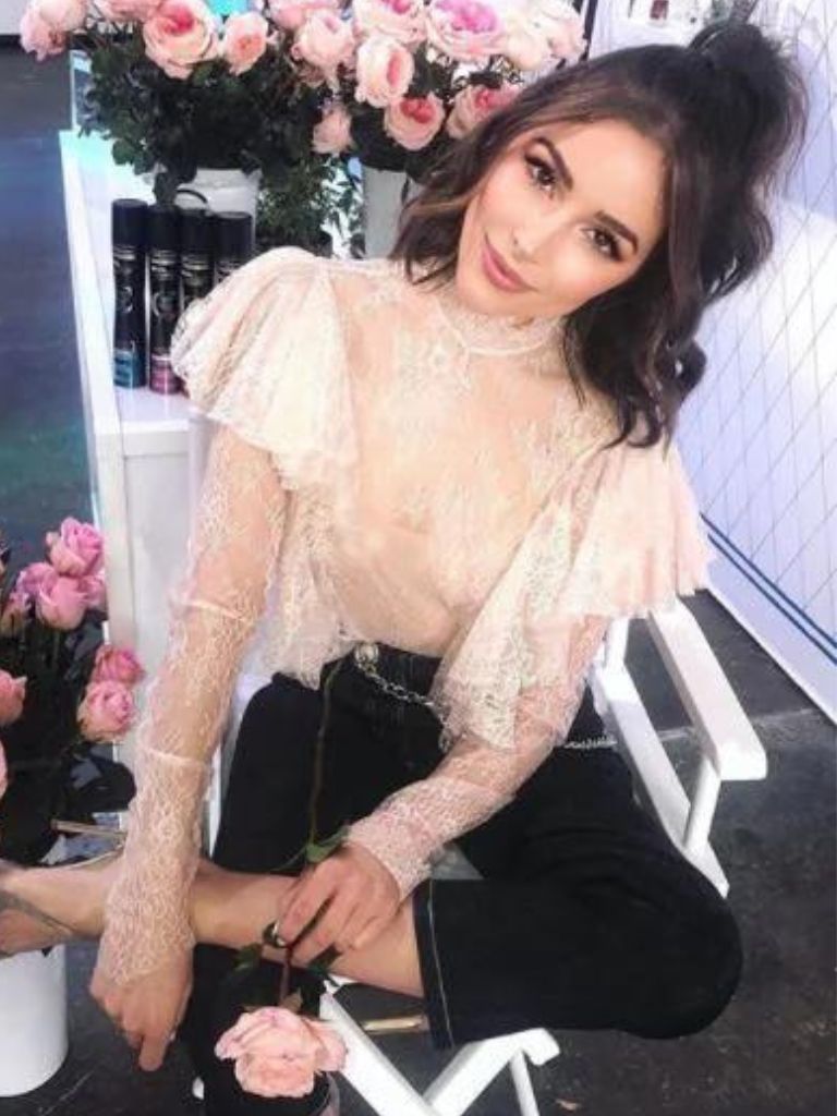 Olivia Culpo with a brunette half-up, half-down bun