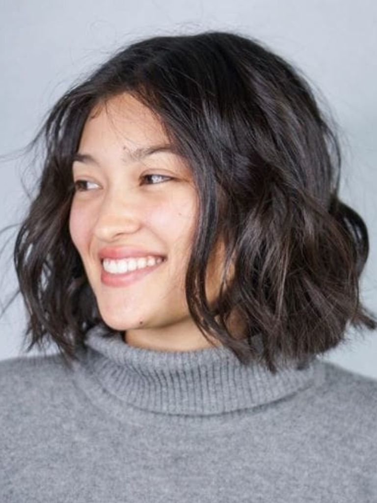 Woman with a dark brunette blunt cut bob