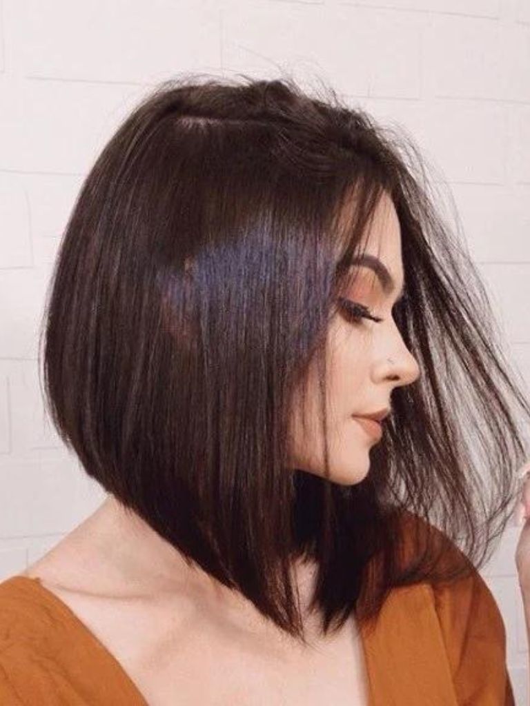 Brunette woman with a sleek angled bob