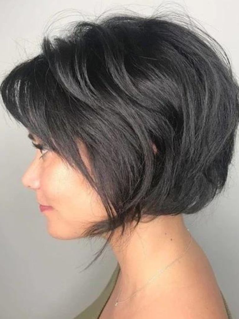 Woman with a dark brunette choppy bob haircut