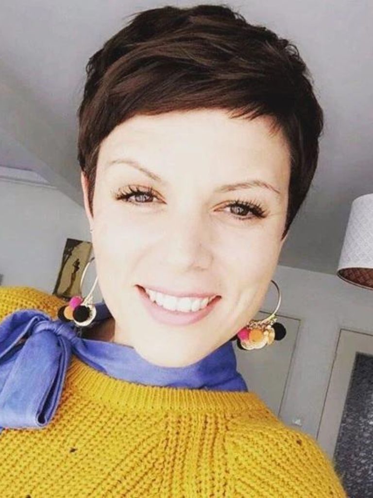 Woman with a very short brunette pixie haircut
