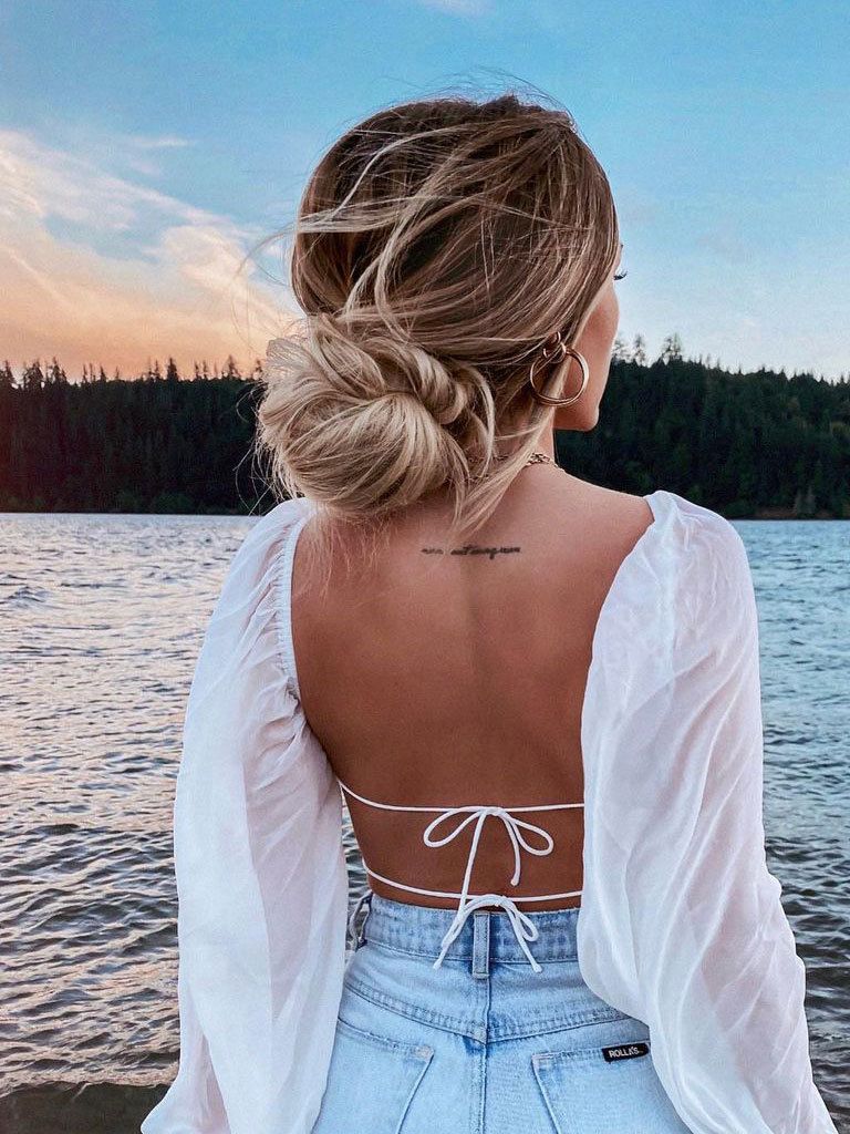 Woman with long blonde hair done in a loose low bun