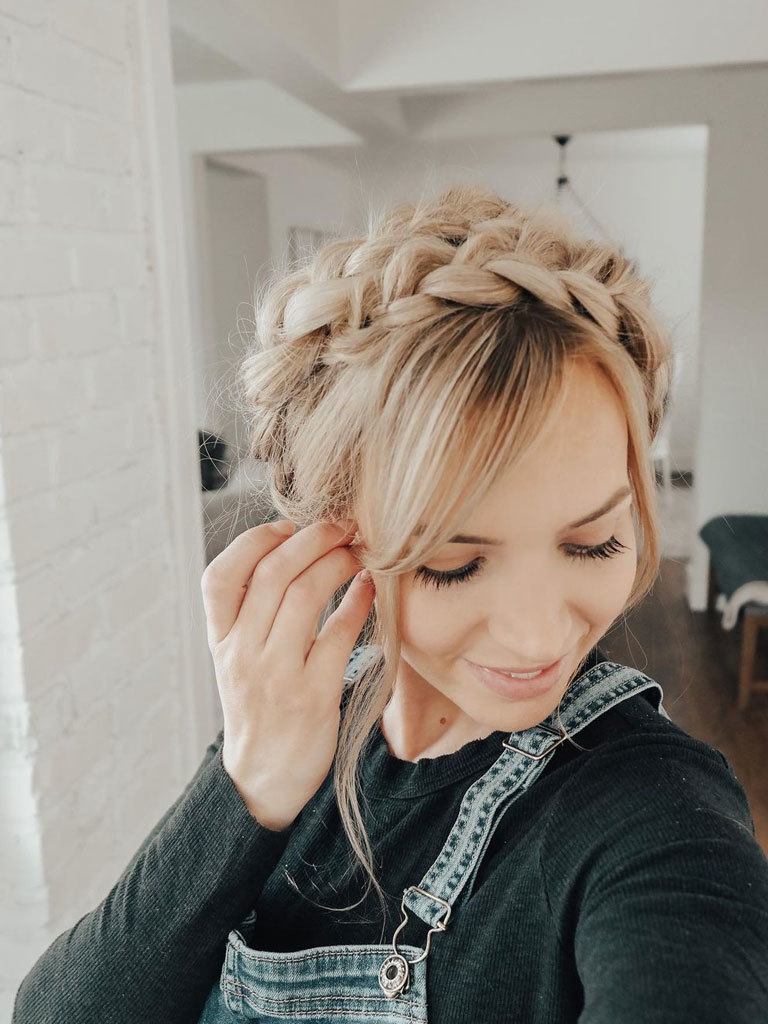 woman with long blonde hair done in a milkmaid braid across her crown