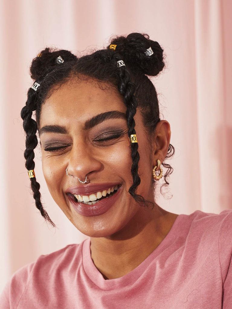Woman with her natural hair styled into space buns