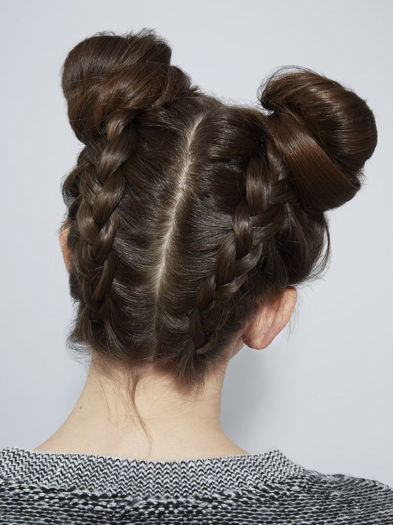 Updos with braids: Back shot of a woman with upside down Dutch braided space buns.