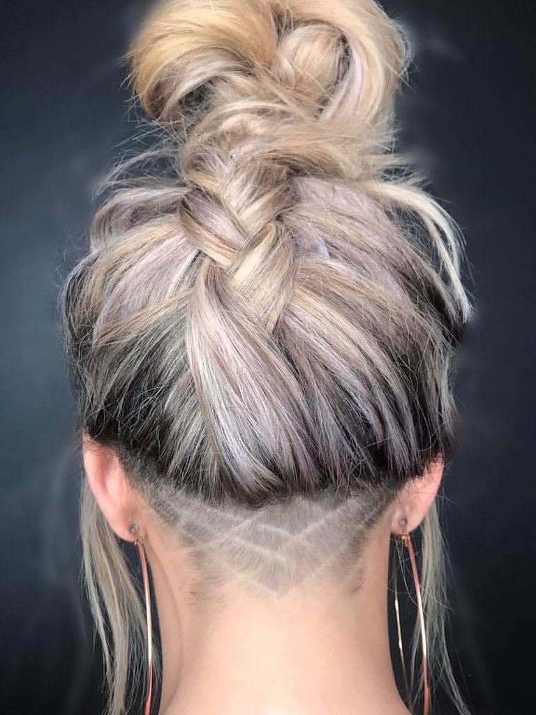 Blonde woman with a braided updo, with hidden undercut with line detail