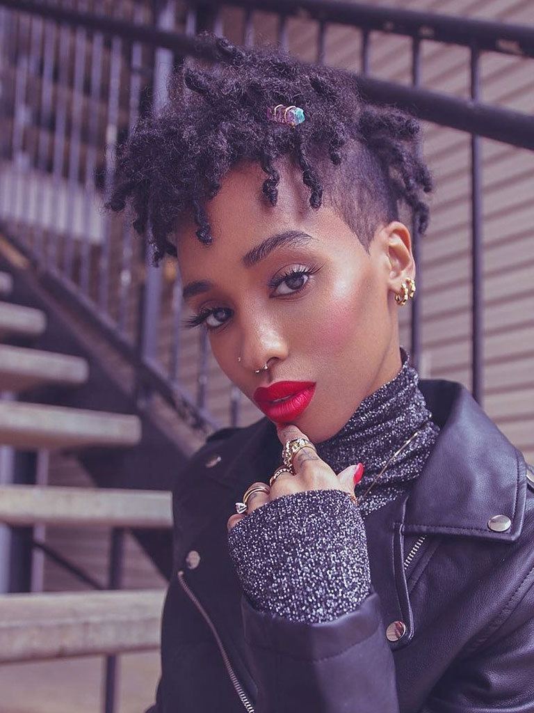 Woman with twisted hairstyle on natural hair, with shaved side and hair decoration