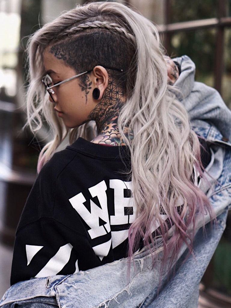 Woman with long grey purple ombre with half shaved hair